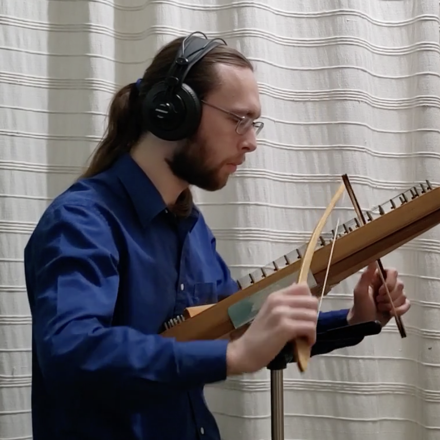 Photo of Forrest Wolf, playing the bowed psaltery